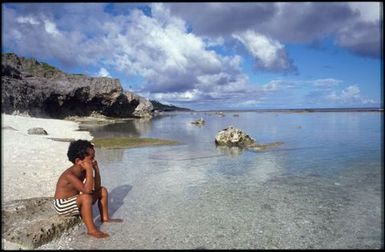 Young boy looking out to sea