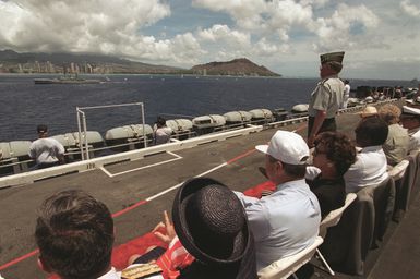 General John M. Shalikashvili (U. S. Army), Chairman, Joint Chiefs of STAFF, salutes from the nuclear-powered aircraft carrier USS CARL VINSON (CVN-70) as a New Zealand frigate passes during a parade of ships off Diamond Head. This is one of the events of the 50th anniversary of V-J Day in celebration of the end of World War II