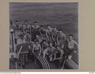 WIDE BAY, NEW BRITAIN. 1945-05-06. CAPTAIN R. TAMER, SKIPPER OF THE AK 82 (FORMERLY THE ALMA-DOEPEL), 16 WATERCRAFT COMPANY, ROYAL AUSTRALIAN ENGINEERS, (1), WITH MEMBERS OF THE CREW ALONGSIDE AN ..