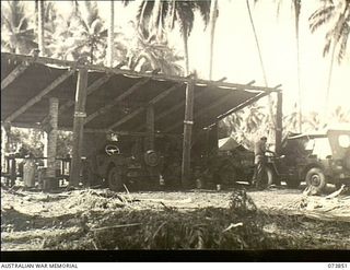 Madang, New Guinea. 1944-06-14. Motor repairs being conducted in the Welding and Blacksmith's workshop at 266th Light Aid Detachment, Headquarters, 15th Infantry Brigade. The unit is located at ..
