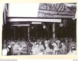 LAE AREA, NEW GUINEA, 1945-06-18. A GENERAL VIEW OF ROYAL AUSTRALIAN ENGINEERS OFFICERS AND THEIR GUESTS, AT THE ENGINEERS' WATERLOO DINNER, HELD AT THE OFFICERS' CLUB, LAE. THIS IS THE FIRST TIME ..
