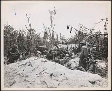 Two marines cautiously advance on a Japanese pillbox on Peleliu