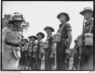 LAE, NEW GUINEA, 1944-03-08. VX20308 MAJOR-GENERAL F.H. BERRYMAN, CBE, DSO, (1), GENERAL OFFICER COMMANDING 2ND AUSTRALIAN CORPS, INSPECTING A GUARD OF HONOUR DRAWN FROM MEMBERS OF THE 29TH ..