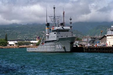 The fleet tug USNS CATAWBA (T-ATF-168) stands moored to a pier