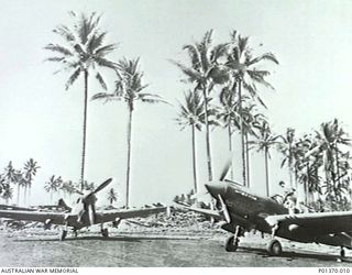 MILNE BAY, PAPUA. 1943. CURTISS P-40E KITTYHAWK FIGHTER AIRCRAFT OF NO. 77 SQUADRON RAAF IN THE DISPERSAL AREA OF GURNEY AIRSTRIP, MILNE BAY, FROM WHICH THE SQUADRON OPERATED. (DONOR: R. CRESSWELL)