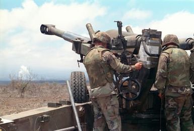 Marines from Bravo Battery, 1ST Battalion, 12th Marines, 3rd Marine Regiment make adjustments to a M198 155mm Medium Towed Howitzer during a combined arms live fire exercise. The M198 is constructed of aluminum and steel, and is air transportable by CH-53E helicopter and C-130 or larger fixed-wing aircraft. Maximum effective range with conventional ammunition is 22,400 meters (13.92 miles) and with a rocket-assisted projectile, 30,000 meters (18.64 miles)