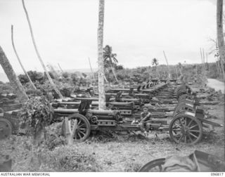 KOKOPO AREA, NEW BRITAIN. 1945-09-16. JAPANESE 150MM GUNS LINED UP ON THE BEACH NEAR KOKOPO