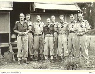 LAE BASE AREA, NEW GUINEA. 1944-12-27. OFFICER OF THE 13TH WORKSHOPS AND PARK COMPANY, OUTSIDE THEIR MESS. IDENTIFIED PERSONNEL ARE:- NX108957 MAJOR R.B.S. HISLOP, OFFICER- IN- CHARGE (1); NX177182 ..