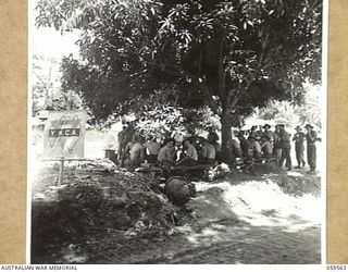 FINSCHHAFEN, AREA, NEW GUINEA, 1943-10-23. COFFEE STALL OF THE YOUNG MEN'S CHRISTIAN ASSOCIATION UNIT, ATTACHED TO THE 9TH AUSTRALIAN DIVISION ESTABLISHED ON THE NORTH BANK OF THE BUMI RIVER. ..