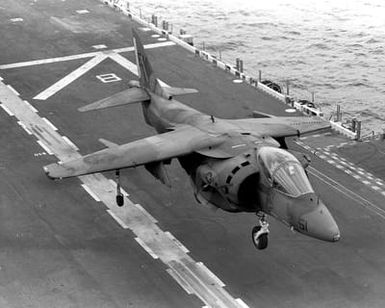 An AV-88 Harrier aircraft attached to Marine Medium Helicopter Squadron 261 (HMM-261) comes in for a landing on the flight deck of the amphibious assault ship USS SAIPAN (LHA-2) during a rehearsal for OPERATION SHARP EDGE. The SAIPAN is on station off the coast of Liberia