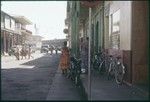 Papeete commercial district: street scene, cargo ship in port