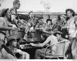 1943-09-25. NEW GUINEA. FALL OF LAE. IN THE FORMER HEADQUARTERS OF THE JAPANESE COMMANDING OFFICER, PTE. J. POLLARD OF GERALDTON, W. AUST., ENTERTAINS THE BOYS ON THE JAP C.O'S PIANO