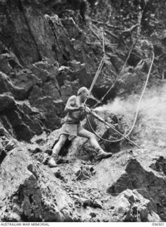 REINHOLD HIGHWAY, NEW GUINEA, 1943-08-31. VX68194 SAPPER W. A. G. DRYSDALE OF THE 2/4TH AUSTRALIAN FIELD SQUADRON, ROYAL AUSTRALIAN ENGINEERS DRILLING ROCK FACE AT THE 19 1/4 MILE POINT
