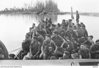 JABA RIVER AREA, BOUGAINVILLE, SOLOMON ISLANDS. 1944-12-18. 15 INFANTRY BATTALION SUPPORT TROOPS LEAVE THE RIGHT BANK TO TRAVEL BY BARGE TO D COMPANY'S NEW POSITION ON THE SOUTH BANK OF THE JABA ..