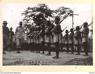 TOL PLANTATION, WIDE BAY, NEW BRITAIN. 1945-07-02. HIS ROYAL HIGHNESS, THE DUKE OF GLOUCESTER, GOVERNOR-GENERAL OF AUSTRALIA (1), INSPECTING A PARADE OF NATIVES ATTACHED TO THE ALLIED INTELLIGENCE ..