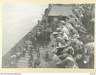 BOUGAINVILLE ISLAND, SOLOMONS. 1944-11-01. TROOPS OF THE 3RD AUSTRALIAN DIVISION HEADQUARTERS AND ATTACHED PERSONNEL ABOARD AN AMERICAN LANDING CRAFT INFANTRY (LCI) AWAITING TRANSPORT TO THE BEACH