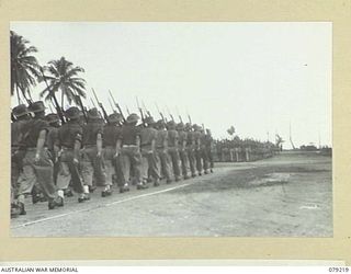 AITAPE, NEW GUINEA. 1945-02-23. TROOPS OF THE 2/11TH INFANTRY BATTALION GIVE EYES RIGHT AS THEY PASS THE GENERAL OFFICER COMMANDING, 6TH DIVISION AT THE CONCLUSION OF HIS INSPECTION OF THE 19TH ..