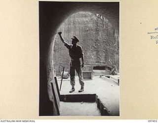 TUNNEL HILL ROAD, RABAUL, NEW BRITAIN. 1945-10-03. THE VIEW FROM THE INSIDE OF A TUNNEL LOOKING OUT. THE JAPANESE MADE EXTENSIVE USE OF TUNNEL SYSTEMS IN THE RABAUL AREA AFTER ABOVEGROUND ..