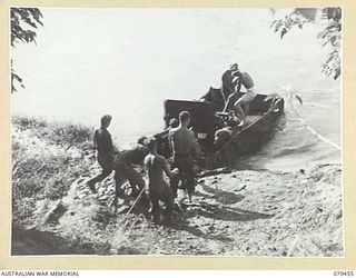 BOUGAINVILLE ISLAND. 1945-03-08. TROOPS OF THE 25TH INFANTRY BATTALION LOADING A TANK ATTACK GUN ON TO IMPROVISED RAFT (WIRE MESH AND A TENT FLY) FOR TRANSPORT TO ONE OF THE UNIT FORWARD COMPANIES ..