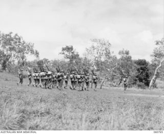 POM POM VALLEY, NEW GUINEA. 1943-11-27. THE GUARD OF THE 2/10TH AUSTRALIAN INFANTRY BATTALION, THE CHAMPION GUARD OF THE 18TH AUSTRALIAN INFANTRY BRIGADE, FALLING IN DURING THE TAKING OF A TRAINING ..