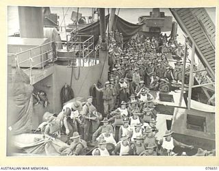 JACQUINOT BAY, NEW BRITAIN. 1944-11-04. TROOPS OF THE 14/32ND INFANTRY BATTALION AT THEIR BOAT STATION ABOARD THE TROOPSHIP, "CAPE ALEXANDER" WHILE THE VESSEL STANDS OFF THE BAY