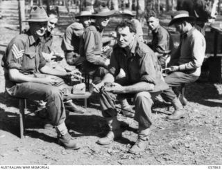 WONDECLA, QLD. 1943-10-07. MEMBERS OF THE 2/7TH AUSTRALIAN INFANTRY BATTALION, 17TH AUSTRALIAN INFANTRY BRIGADE, WHO HAVE RETURNED FROM NEW GUINEA, ENJOY A MEAL OF GOOD FOOD, NOT DEHYDRATED FOOD. ..