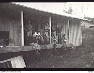 WAU, NEW GUINEA. 1942-08-30. NO 6 CAMP, BULOLO VALLEY. MEMBERS OF NO 8 SECTION, 2/5TH INDEPENDENT COMPANY. ALL STORES, EQUIPMENT AND AMMUNITION THAT COULD NOT BE CARRIED WAS DUMPED IN THIS STORE, ..