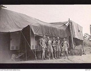 SEVENTEEN MILE, NEW GUINEA. 1943-09-23. MEMBERS OF THE 2/1ST AUSTRALIAN ARMY TOPOGRAPHICAL SURVEY COMPANY STANDING ALONGSIDE THEIR MODERN CAMERA TRAILER. LEFT TO RIGHT: VX18777 CORPORAL (CPL) A. E. ..