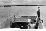 Team members preparing to unload as their boat approaches Enjebi Island, summer 1964