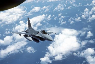 An air-to-air right front view of an F-16 Fighting Falcon aircraft in preparation for refueling, taken from a KC-135 Stratotanker aircraft during a flight from March Air Force Base, Calif., to Hickam Air Force Base, Hawaii