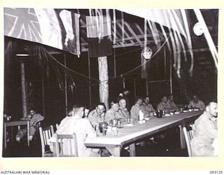 LAE AREA, NEW GUINEA, 1945-06-18. THE GOC'S TABLE AT THE OFFICERS' CLUB, LAE, ON THE OCCASION OF THE ENGINEERS' WATERLOO DINNER. THIS IS THE FIRST TIME SINCE THE BEGINNING OF THE WAR THAT A ..