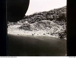 Kairiru Island, New Guinea, 1945-06-18. Aerial view, taken at an altitude of 200 feet from the rear gun position on the side of a United States Army Air Force (USAAF) Consolidated B-24 Liberator ..