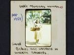 Lake Murray woman holding a baby, small babies are carried in wicker baskets, [Papua New Guinea], c1958