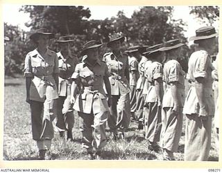 LAE, NEW GUINEA. 1945-10-22. LIEUTENANT COLONEL M.J. SPENCER, ASSISTANT CONTROLLER AUSTRALIAN WOMEN'S ARMY SERVICE (3), SERGEANT G. TURMINE (1), CAPTAIN P.E. RYAN (2) AND CAPTAIN J. TREGEA (4), ..