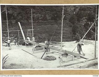 BALASANA, NEW GUINEA, 1943-07-06. KEEL BEING SHAPED FOR A NEW VESSEL AT THE SHIPYARDS OF THE 1ST AUSTRALIAN WATER TRANSPORT GROUP (SMALL CRAFT) MAINTENANCE BASE