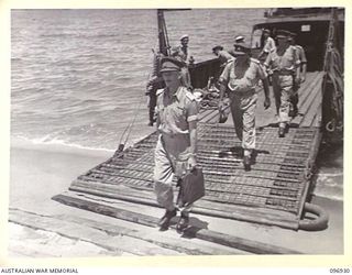KAHILI, BOUGAINVILLE. 1945-09-10. BRIGADIER S.F. LEGGE, WHO IS IN CHARGE OF THE SURRENDER COMMISSION, STEPPING ASHORE FROM A LANDING BARGE. HE IS VISITING THE BUIN LIAISON PARTY FROM HEADQUARTERS 2 ..