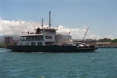 Starboard side view of the Ferryboat YFB-87 making its hourly crossing from near the USS ARIZONA Memorial to the Ford Island landing. A new causeway bridge which will eliminate the need for the Ford Island Ferry, is under construction and will be completed in early 1998