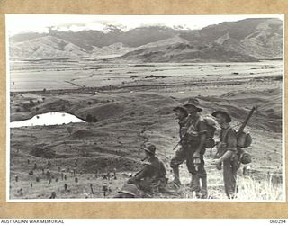 RAMU VALLEY AREA, NEW GUINEA. 1943-11-08. TROOPS OF THE 2/27TH AUSTRALIAN INFANTRY BATTALION PAUSE ON A HIGH RIDGE OVERLOOKING THE RAMU VALLEY. SHOWN ARE: PRIVATE F. DOWSETT (1); SX17075 PRIVATE W. ..