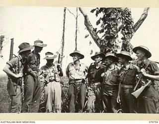 KELANOA, NEW GUINEA, 1944-03-04. OFFICERS AND NON COMMISSIONED OFFICERS FROM "A" COMPANY, 1ST PAPUAN INFANTRY BATTALION. THE TOTAL COMPANY IS COMPOSED OF 5 OFFICERS, 15 EUROPEAN SERGEANTS, AND 120 ..