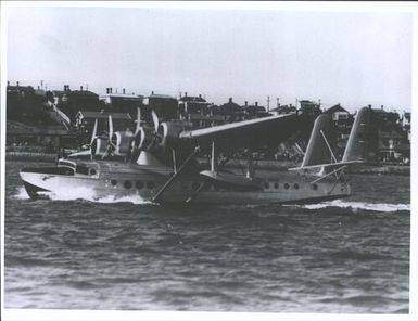 Samoan Clipper (Pan American Airways System) landing on harbour opposite Devonport