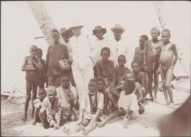 Captain William Sinker of the Southern Cross with men and children at Honggo, Solomon Islands, 1906 / J.W. Beattie