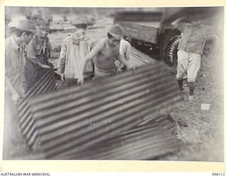 MUSCHU ISLAND, NEW GUINEA. 1945-09-11. JAPANESE SOLDIERS STACKING STORES FOR THE BUILDING OF HOSPITAL WARDS. THIS FOLLOWED THE SURRENDER OF THE ISLAND BY REAR-ADMIRAL SATO TO MAJOR GENERAL ..