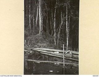 NEW GUINEA. APRIL, 1944. OPEN AIR MESS TABLES USED BY AUSTRALIAN TROOPS AT BATTALION HEADQUARTERS ON SHAGGY RIDGE