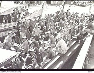 RABAUL, NEW BRITAIN, 1945-12-08. HIGH PRIORITY DISCHARGE PERSONNEL OF 11 DIVISION ABOARD A LANDING CRAFT WHICH WILL TAKE THEM OUT TO THE TROOPSHIP HMAS WESTRALIA FOR RETURN TO AUSTRALIA