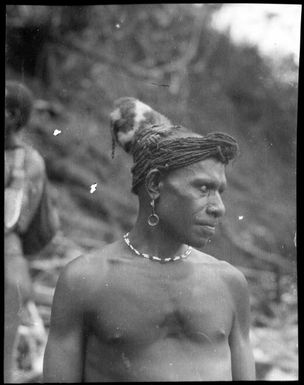 Man with headwear made from cuscus fur, Awar, Sepik River, New Guinea, 1935 / Sarah Chinnery