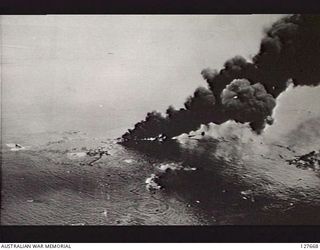 KAVIENG, NEW IRELAND. ? 1944-03. AERIAL PHOTOGRAPH OF A DUMMY RUN OVER ENEMY (JAPANESE) SHIPPING WHICH HAD BEEN BOMBED PREVIOUSLY, DISCLOSING THE FLOATING WRECKAGE. PHOTO TAKEN THROUGH OPEN BOMB ..