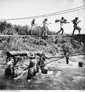 1942-11-19. NEW GUINEA. KOKODA. ENGINEERS BUILDING A BRIDGE - ONE OF THE MANY THAT WILL BE NECESSARY ALONG THE TRACK FROM KOKODA TO BUNA