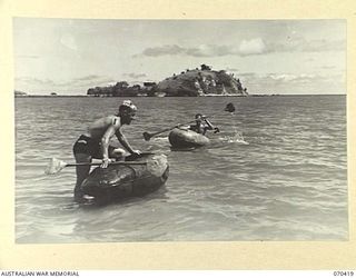 PORT MORESBY, PAPUA, NEW GUINEA, 1944-02-14. VX37327 GUNNER H. WOOLCOCK (1) AND VX55242 GUNNER L.T. CURRY (2) MEMBERS OF THE 2/4TH FIELD REGIMENT USING IMPROVISED CANOES MASDE FROM THE BELLY TANKS ..