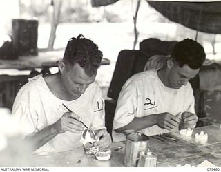 MILILAT, NEW GUINEA. 1944-08-23. NX156727 STAFF SERGEANT G.W. DALE (1) AND NX122829 CORPORAL J. WALSH (2) DENTAL MECHANICS, 77TH DENTAL UNIT