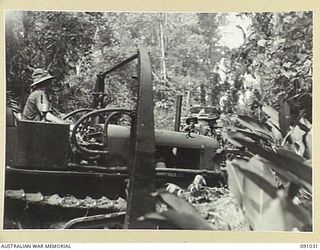 BOUGAINVILLE. 1945-04-17. A BULLDOZER OF 15 FIELD PARK COMPANY, ROYAL AUSTRALIAN ENGINEERS, MAKING A DETOUR THROUGH JUNGLE FOR A TANK CROSSING ACROSS DAWE CREEK DURING THE HATAI JUNCTION ACTION. ..